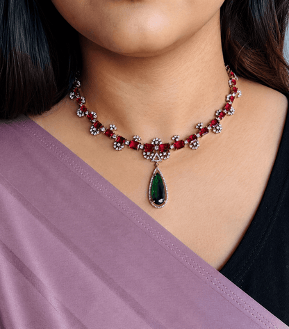 Elegant South Indian necklace with red and green gemstones, perfect for bridal or temple wear.