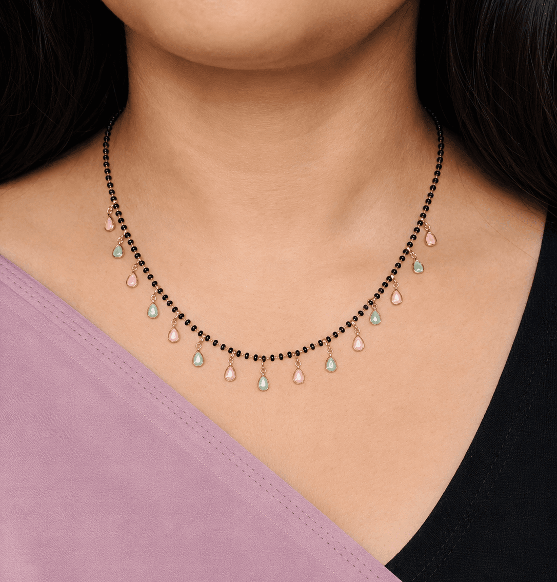 Elegant South Indian necklace with black beads and pastel teardrop charms, perfect for bridal or temple wear.